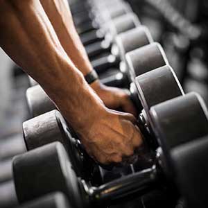 person grabbing some free weights